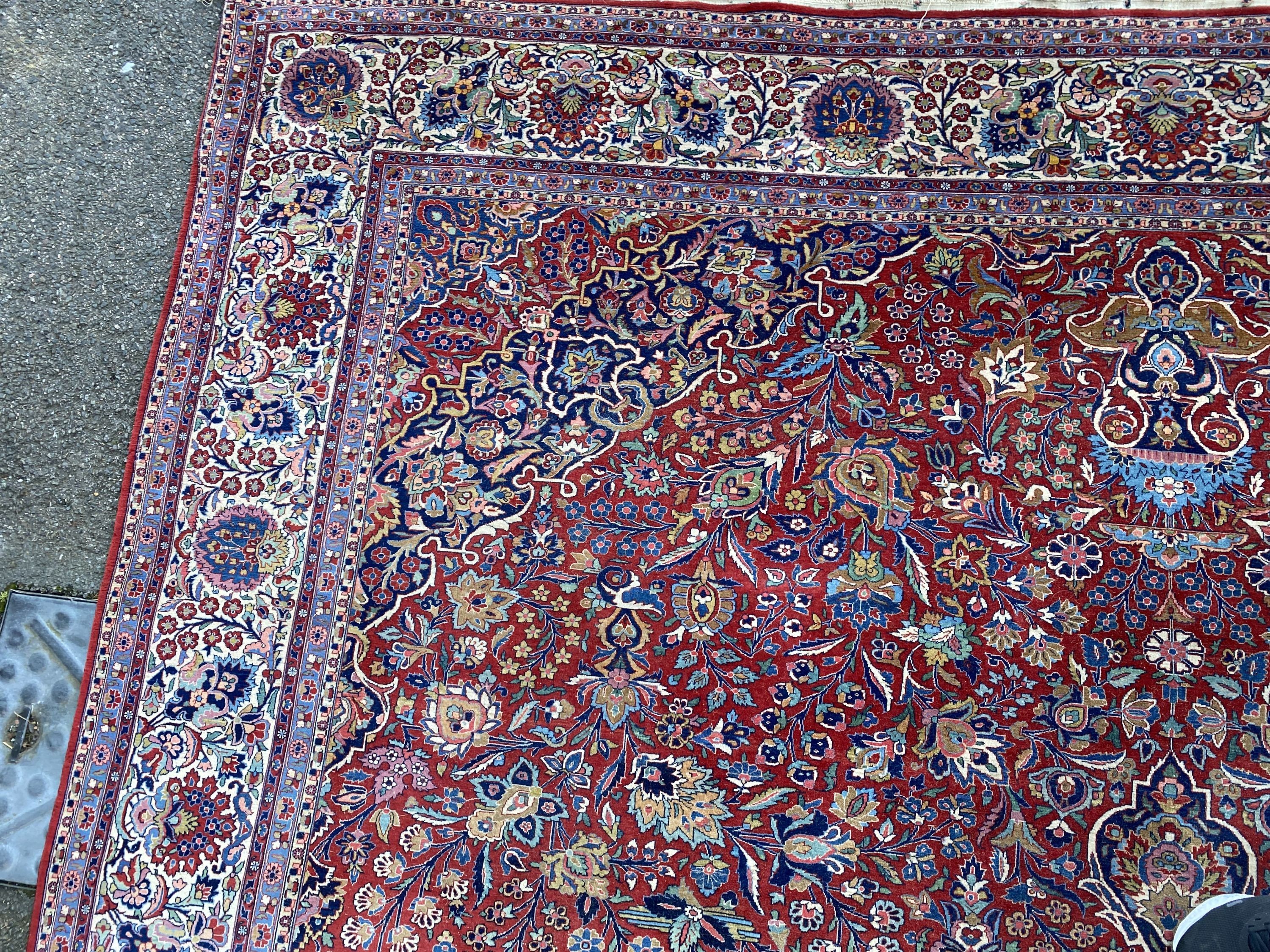 A Tabriz red ground carpet with, first half 20th century, 510cm x 355cm